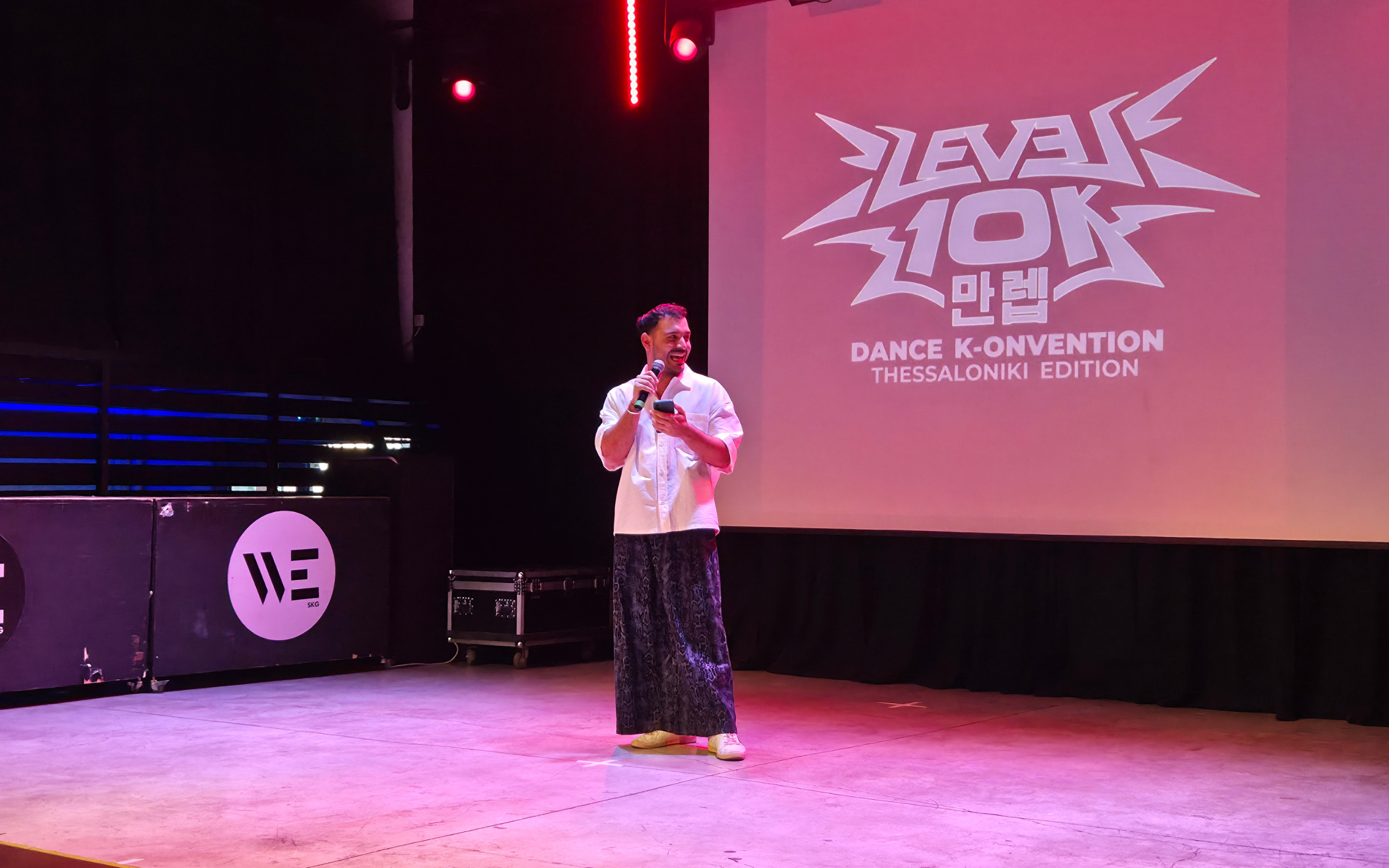 Angelos Petrou, host of the Level 10K K-pop cover competition, addresses participants during the event